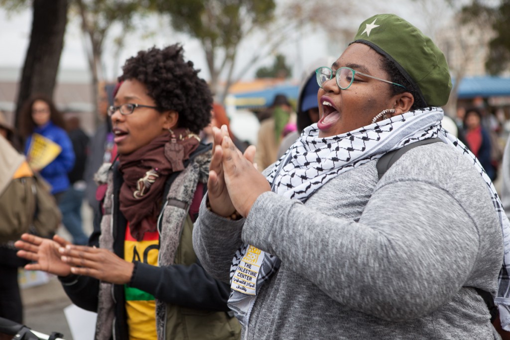 Marchers singing and clapping