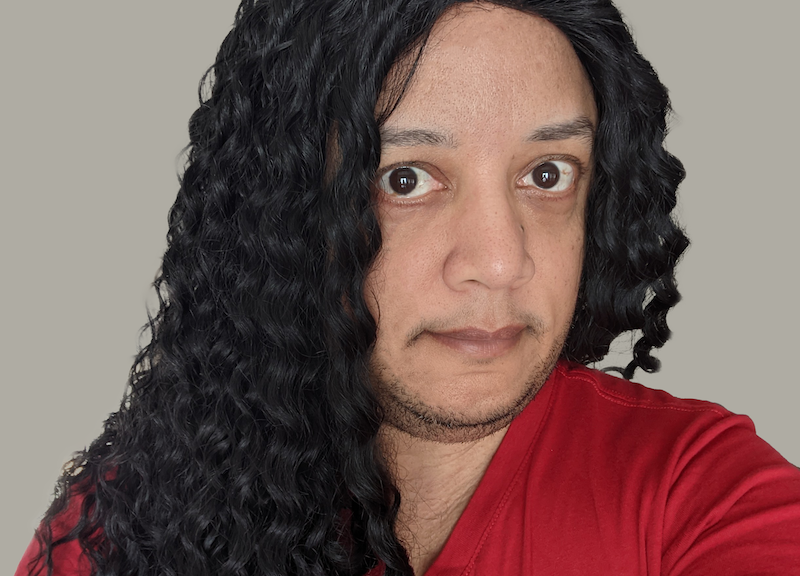 Pax with long wavy black hair and a red T-shirt.